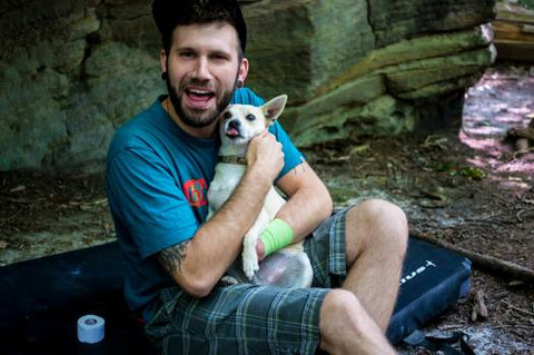 Jon Sedor with his dog at the crag
