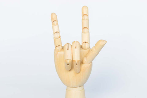 Wooden hand model making a rocker sign