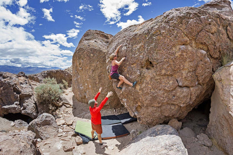 Two climbers bouldering outside