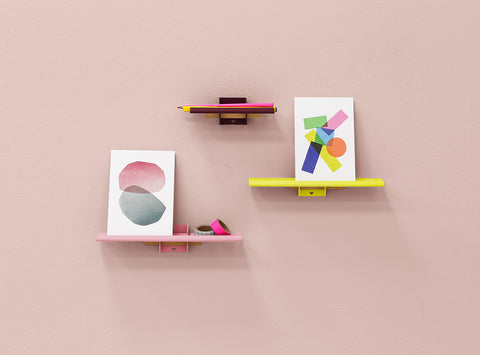 Sweet wall system wall shelves in the colors purple, yellow and pink with art card
