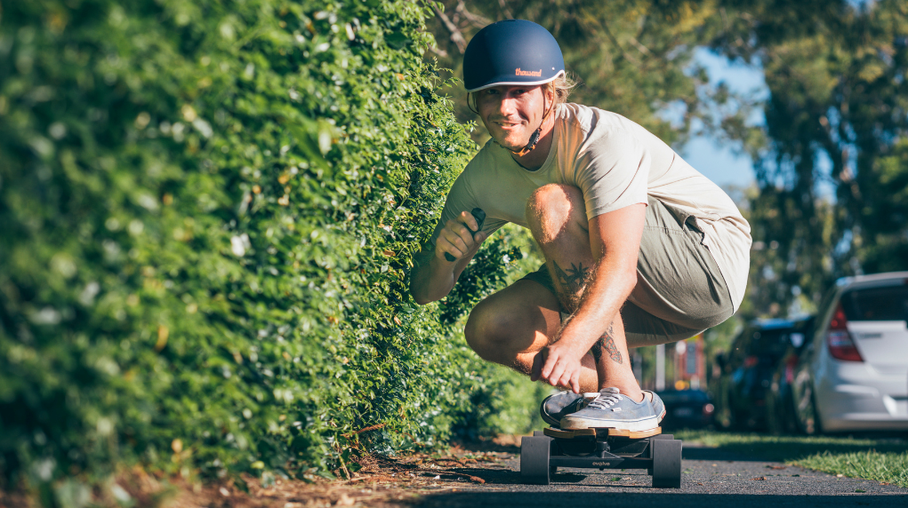 happy guy riding an electric skateboard