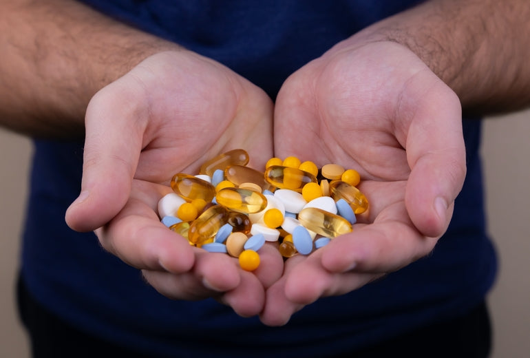 Hände voll mit verschiedenen Tabletten