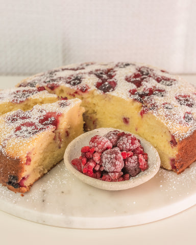 raspberry ricotta cake with bowl of raspberries