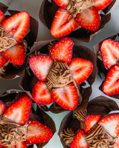 Chocolate muffins with strawberries on top