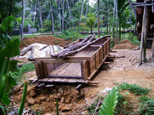 A wood-and-metal sieve used in separating the stones from the soil and debris.