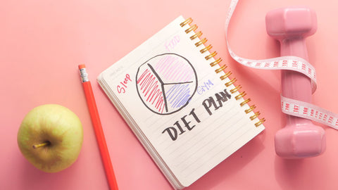 Diet Plan with Almond Nut, Dumbbells, Apple on Table