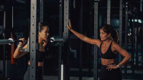 Female Trainers and Woman Lifting Weights in Gym
