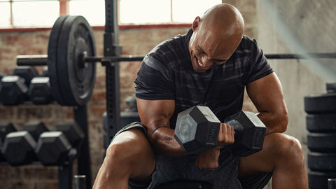 Strong Man Lifting Weight at Gym