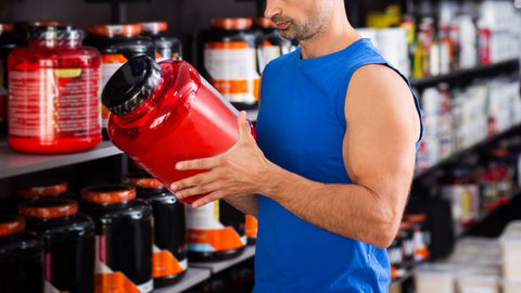 man choosing fitness supplements