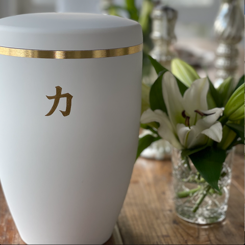 White funeral urn handpainted with liquid gold leaf with the Japanese Kanji character for 'Strength'