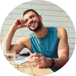 A man laughing while sitting at a table.