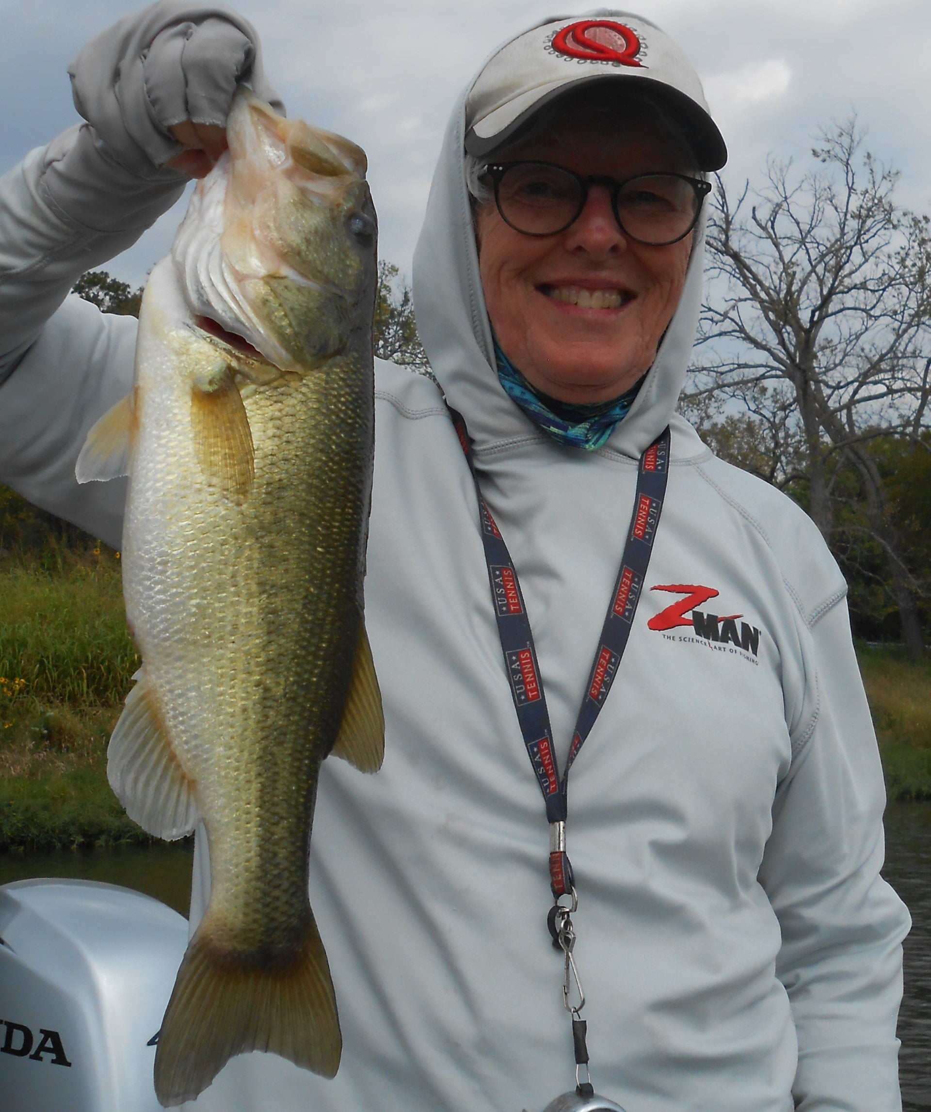 Pattie with a Large mouth bass in her hand.