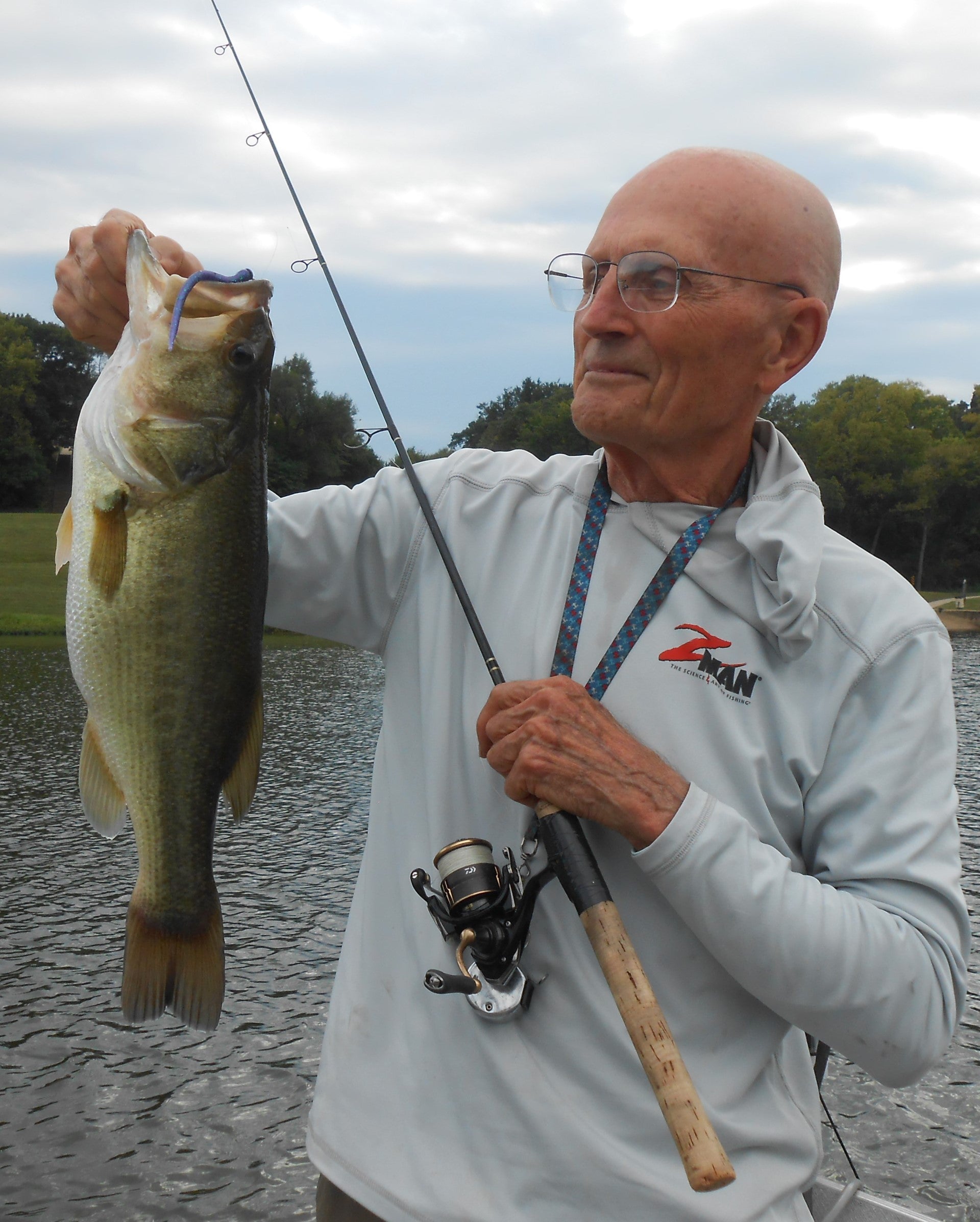 Ned Kehde with a large mouth bass in his hand.