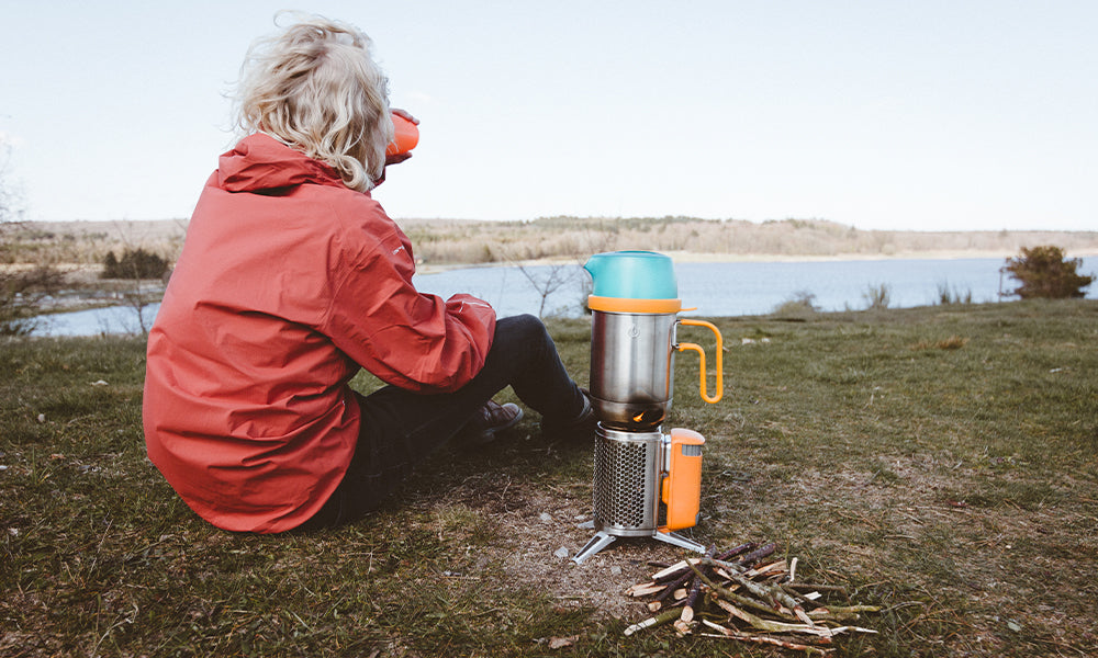 Person enjoying coffee made with CampStove Complete Cook Kit.