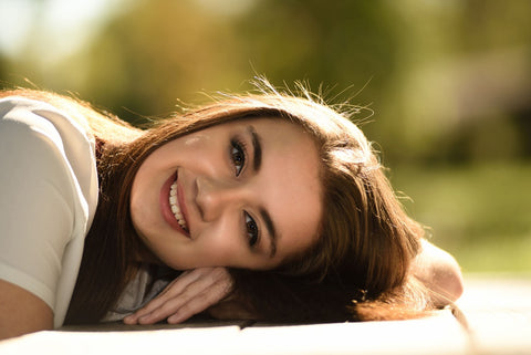 A woman resting her head and smiling