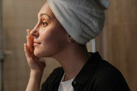 A person applying a skincare product to their face