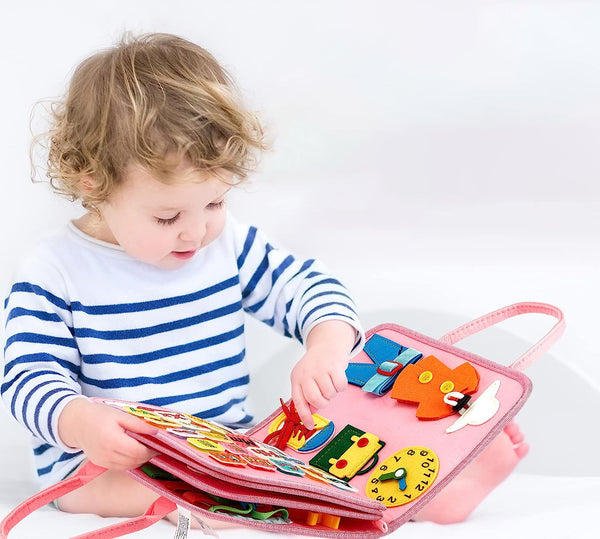 Girl playing with Montessori busy book