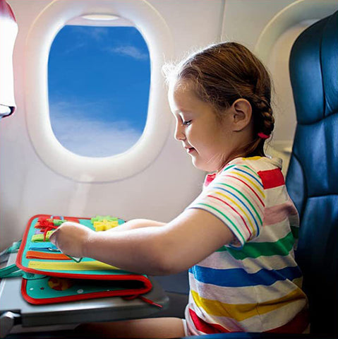 Child playing with busy book on the plane