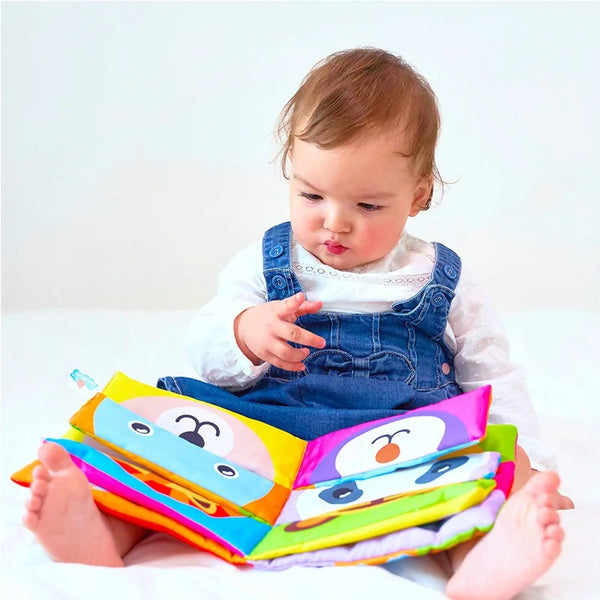 Baby girl playing with mix and match cloth book