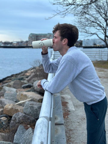 Drinking coffee after a run on Boston Harbor in East Boston