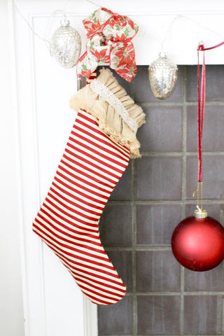 stripped stocking over fireplace with bow