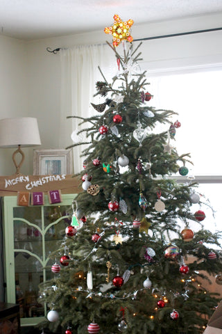 decorated mix matched ornaments with mint green cabinet and light up star