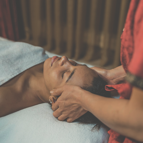 head massage with oil by hand