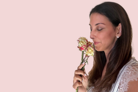 Woman smelling flowers - Aromatherapy in Natural Ayurvedic Skin Care