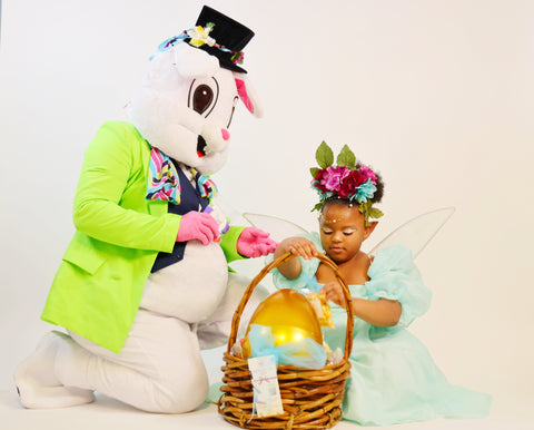 Thhe easter bunny holding an easter basket for a tiny fairy.