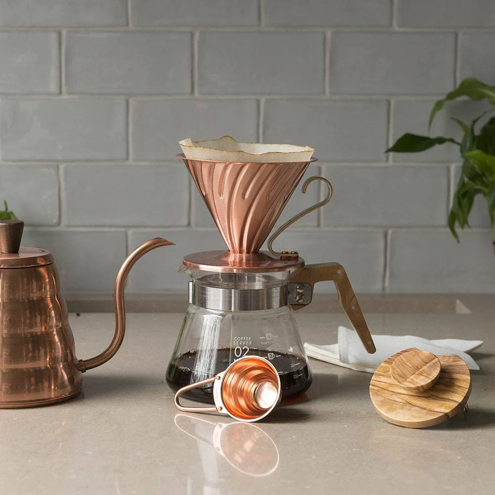 https://cdn.shopify.com/s/files/1/0667/4599/1448/files/ground-coffee-society-hario-v60-copper-dripper-02-in-use.webp?v=1695885047&width=1000