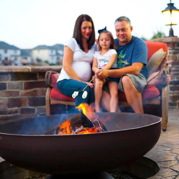 Image of Ohio Flame Patriot Round Steel Fire Pit with a family in the background