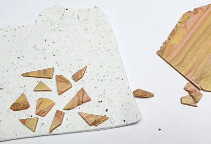 Chop pieces of marbled clay and position with space between each piece on White Granite