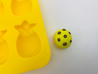 photo shows yellow ball with brown spots