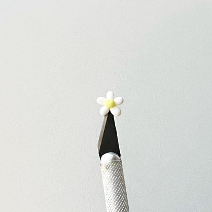 photo shows tiny flower on tip of Exacto blade