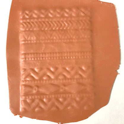 photo shows clay pressed into stamp