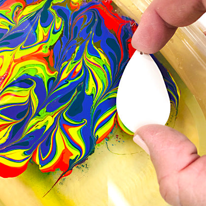 photo shows clay about to be dipped into marbled colors