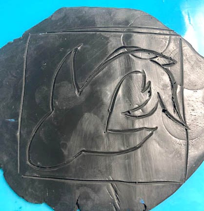 photo shows traced outline of animal on clay