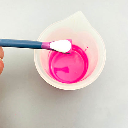 photo shows adding measuring spoon of white