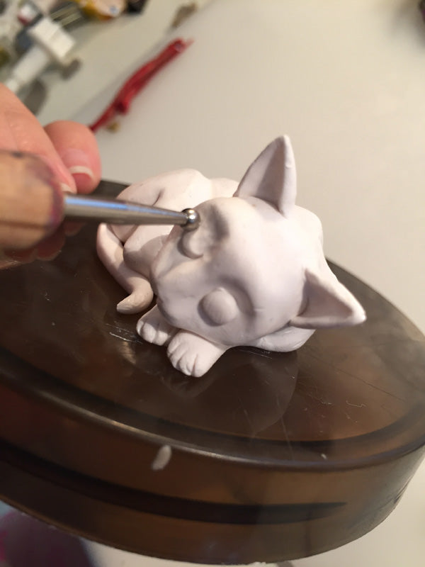 smooth eyes of polymer clay sleeping cat