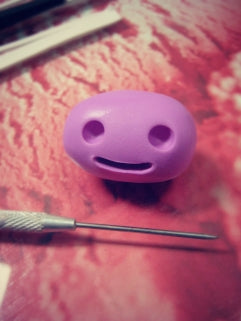 using polymer clay needle tool to create monster face