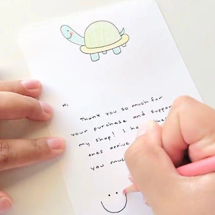 handwritten card with a turtle and smiley face drawn on