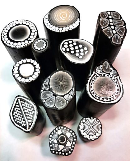 Intricate black and white polymer clay designs