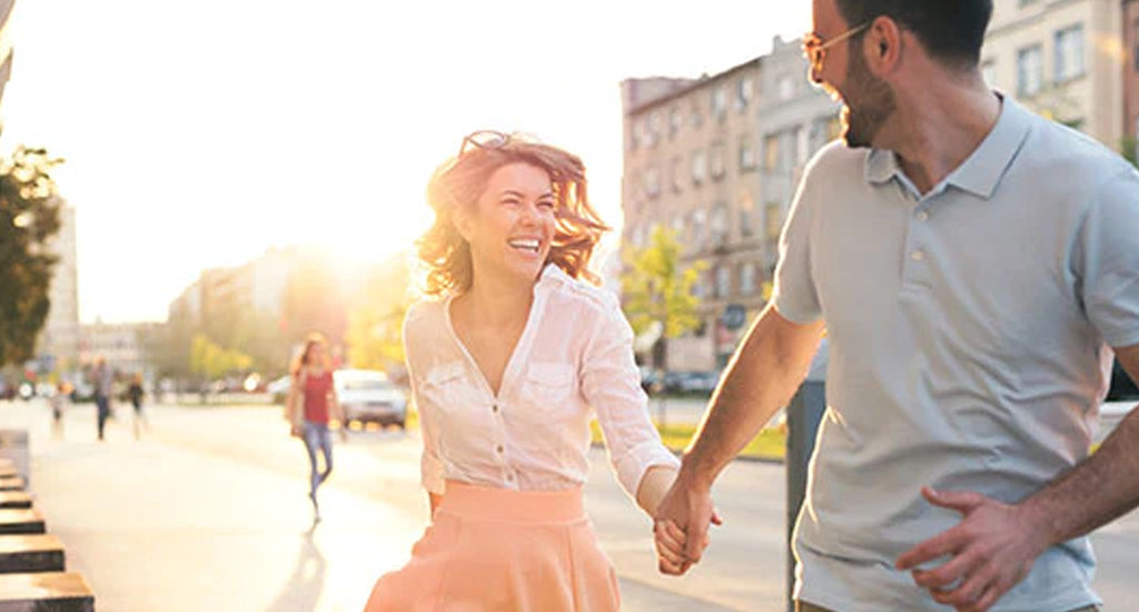 Happy couple walking down the street - Shimansky