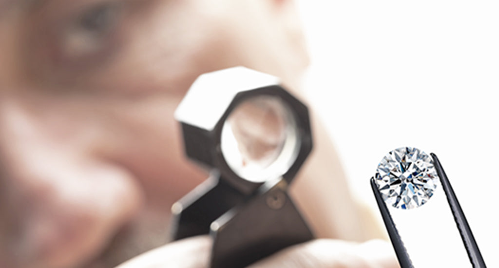 Expert inspecting a diamond - Shimansky