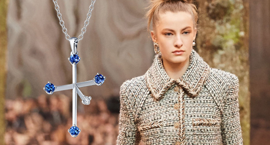 Shimansky Tanzanite Southern Cross pendant next to a woman wearing a fashionable tweed jacket