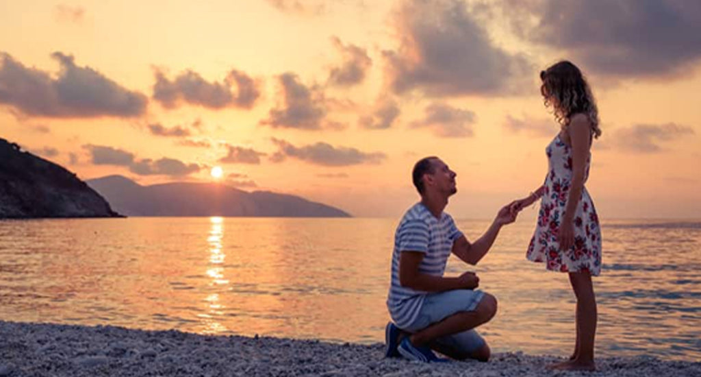 Couple on the beach proposing