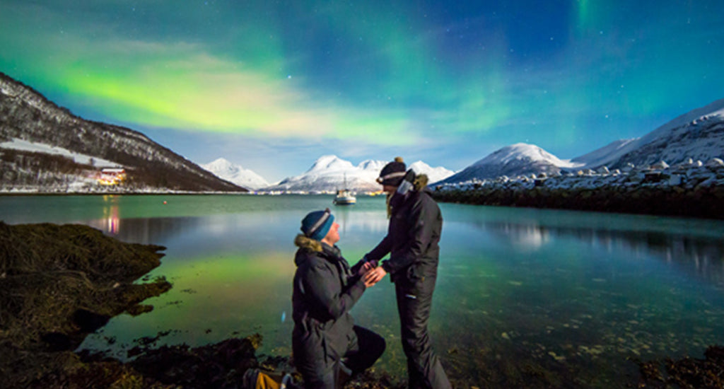 Couple proposing under the Northern lights