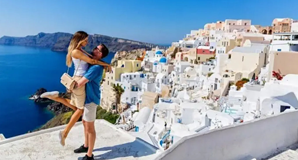 Happy couple with Santorini in the background