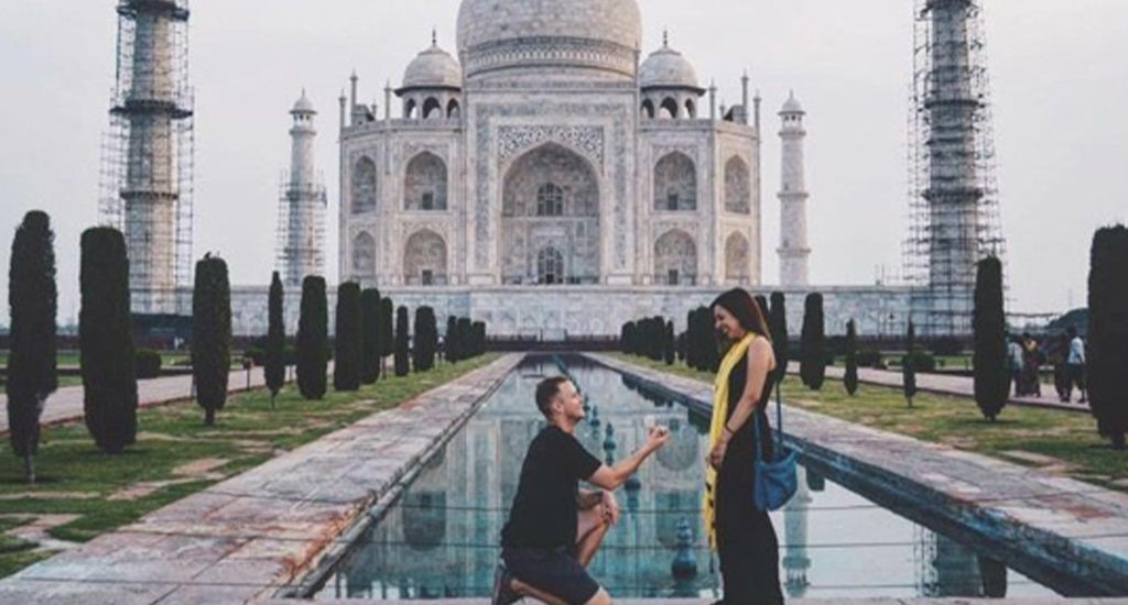 Couple getting engaged in front of the Taj Mahal in India