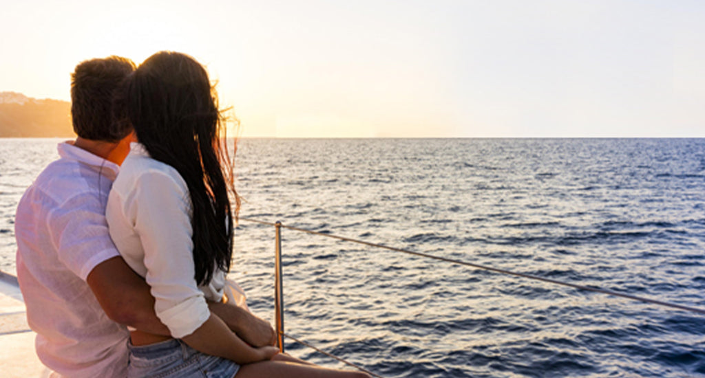 Couple enjoying the beautiful sunset on a cruise